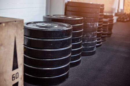 Stacked heavy weights in the crossfit gym.