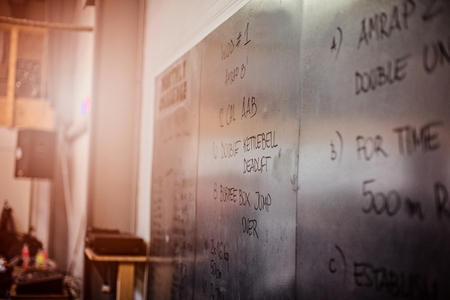 Crossfit workout of the day. Metal board with written crossfit exercisesの写真素材