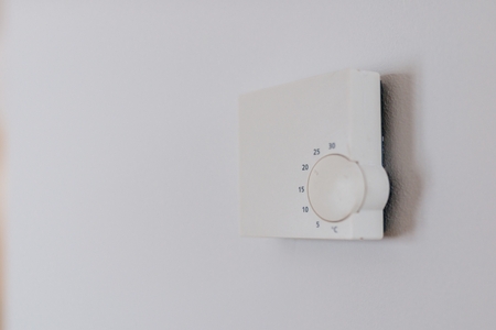 Home heating regulating thermostat on the wallの写真素材