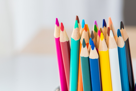 Wooden coloured pencils in office cup on bright background.の写真素材