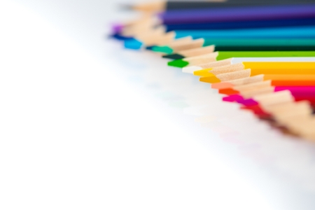 Coloured wooden pencils in row on white backgroundの写真素材