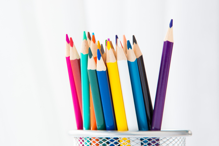 Wooden coloured pencils in office cup on bright background.の写真素材