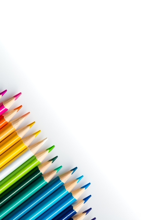 Wooden coloured pencils in row on white background. Copyspaceの写真素材