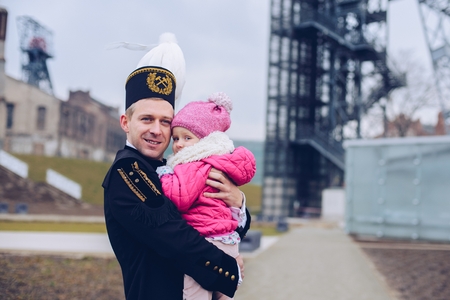 Black coal foreman miner in gala uniform with his child. Polish miner. Katowice, Silesia, Polandの写真素材
