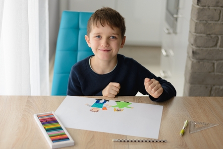 Happy 8 years boy child drawing a greeting card for his grandma for Grandma Day. Happy Grandmother Day!の写真素材