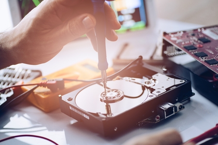 Technician repairing broken hard disk drive. Data recovery conceptの写真素材