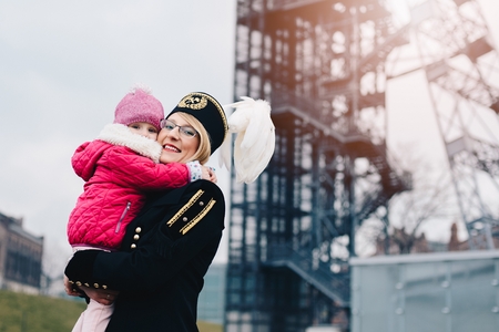 Working woman black coal miner with her child. Working motherの写真素材