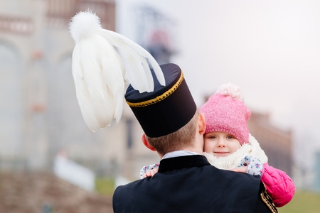 Black coal miner in gala uniform with his child. Working fatherの写真素材