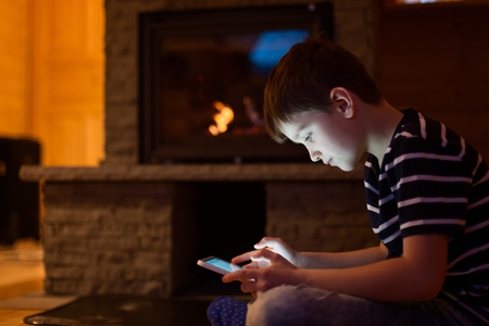 Eight years old boy child using digital tablet at homeの写真素材