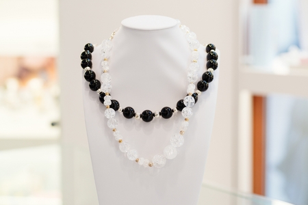 Two necklaces on neck stand display in a jewelry storeの写真素材