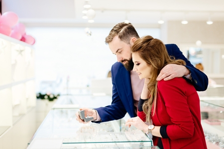 Young couple buying ring in jewelry store. Valentines Day giftの写真素材