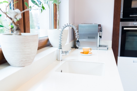 Modern kitchen faucet and sink in kitchenの写真素材