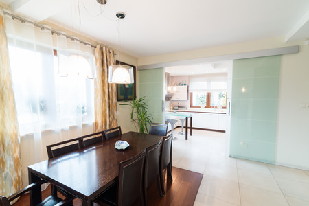 House dining room with big wooden tableの写真素材