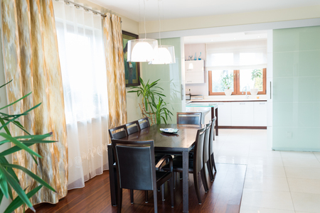 Dining room with big brown wooden tableの写真素材