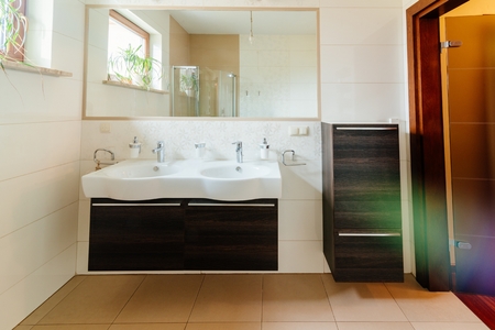 Modern bathroom with double washbasin and mirrorの写真素材