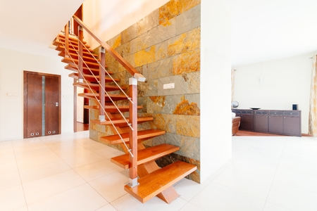 Modern brown wooden stairs with balustrade in hallの写真素材