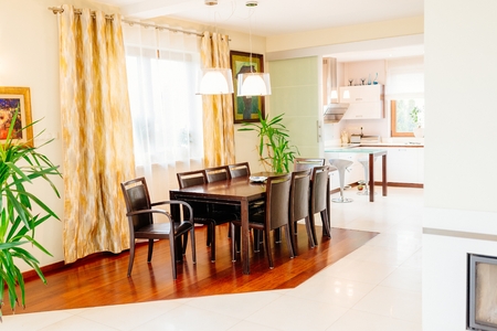Dining room with big brown wooden tableの写真素材