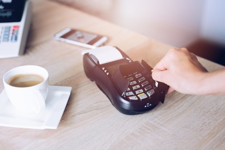 Woman paying with credit card in cafe. Credit card paymentの写真素材