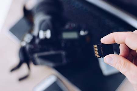 Man holding memory card for dslr camera. Photography business.の写真素材