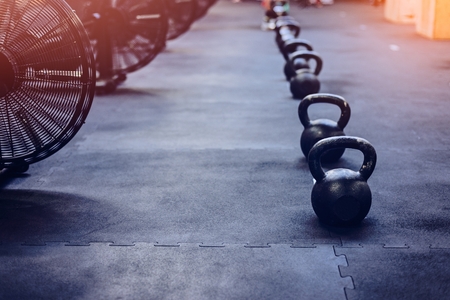 Metal heavy kettlebell weights on the gym floorの写真素材