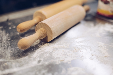 Two wooden rolling pins on the tableの写真素材
