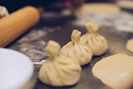 Raw uncooked khinkali. Traditional Georgian dumplings with meat. Georgian foodの写真素材