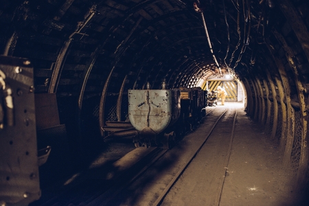 Underground train in black coal mine tunnel. Silesia, Polandの写真素材