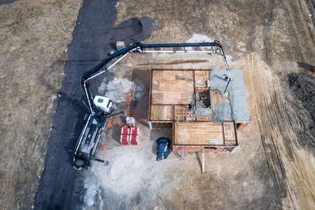 Pouring concrete from a concrete mixer onto the foundations of the house. Building a houseの写真素材