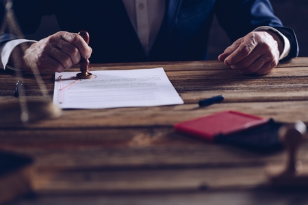 Male lawyer or notary stamping document in his in office. Law conceptの写真素材