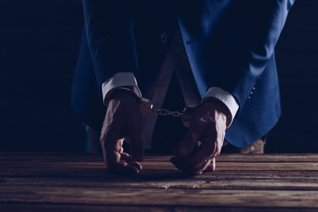 Arrested male businessman with handcuffs. Law and corruption conceptの写真素材