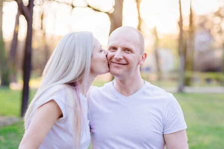 Couple kissing in park. Happy family in the parkの写真素材