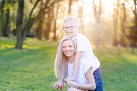 Mother hugging her son. Mother's Day. Happy family in the parkの写真素材