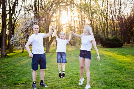 Family jump in park. Happy family in the parkの写真素材