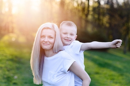 Mother hugging her son. Mother's Day. Happy family in the parkの写真素材