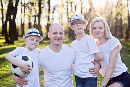 Happy family portrait in park. Happy family in the parkの写真素材