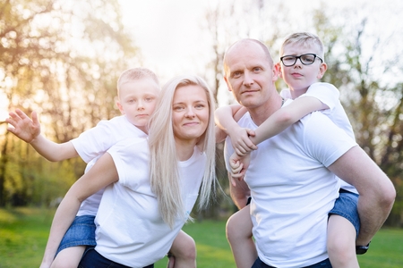 Parents and children portrait in park. Happy family in the park