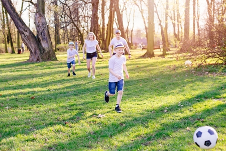 Family playing football in park. Happy family in the parkの写真素材