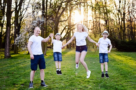 Family jump in park. Happy family in the parkの写真素材