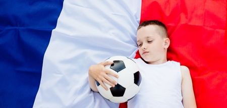 Disappointed France national football team. Child boy with football ball and French flagの写真素材