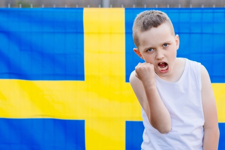 Sweden national football team. Child boy with football ball and Swedish flagの写真素材