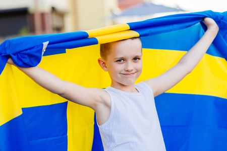 Sweden national football team supporter. Child boy with Sweden flag. Football fanの写真素材