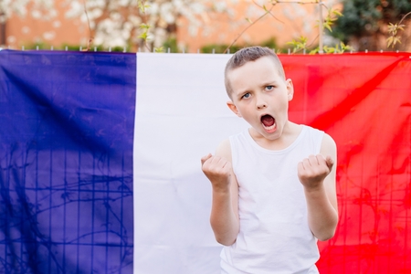 Happy child boy with France national flag. French football fanの写真素材