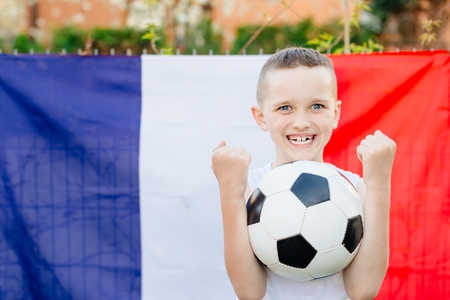 Happy child boy with France national flag. French football fanの写真素材