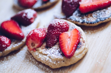 Fried pancakes with strawberries and powdered sugarの写真素材