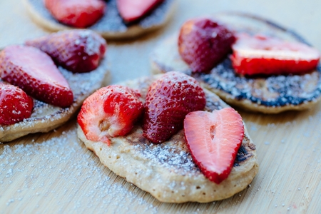 Fried pancakes with strawberries and powdered sugarの写真素材