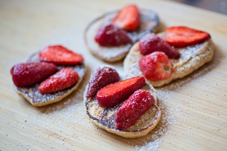 Fried pancakes with strawberries and powdered sugarの写真素材