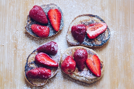 Fried pancakes with strawberries and powdered sugarの写真素材