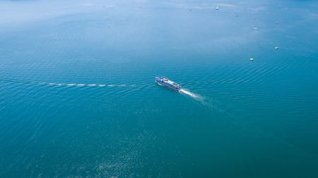 Aerial drone view at cruise boat on beautiful blue lakeの写真素材