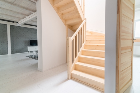 Pine stairs in hall. Modern, bright attic apartment.の写真素材