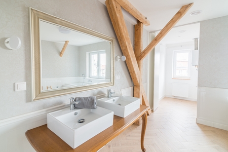 White wash basins in loft bathroom. Modern, bright attic apartment.の写真素材
